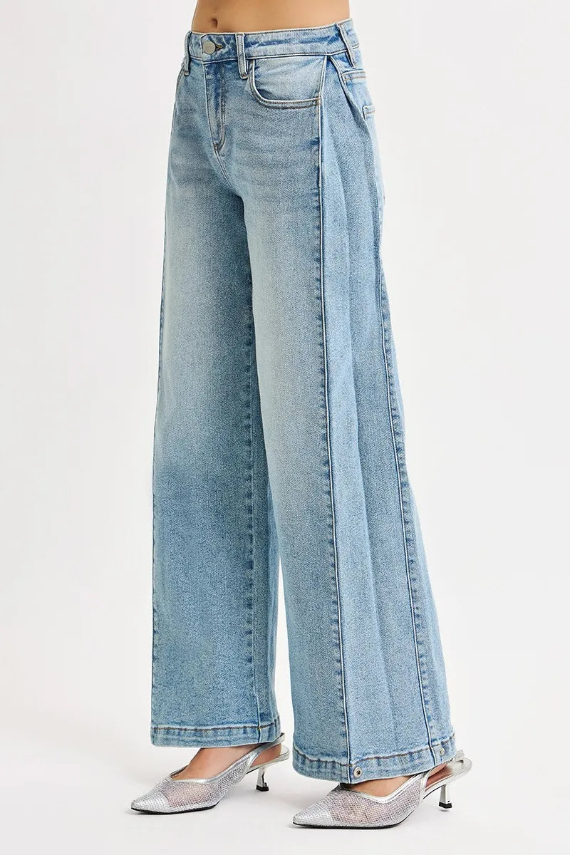 Light blue wide-leg jeans worn by a person on a white background