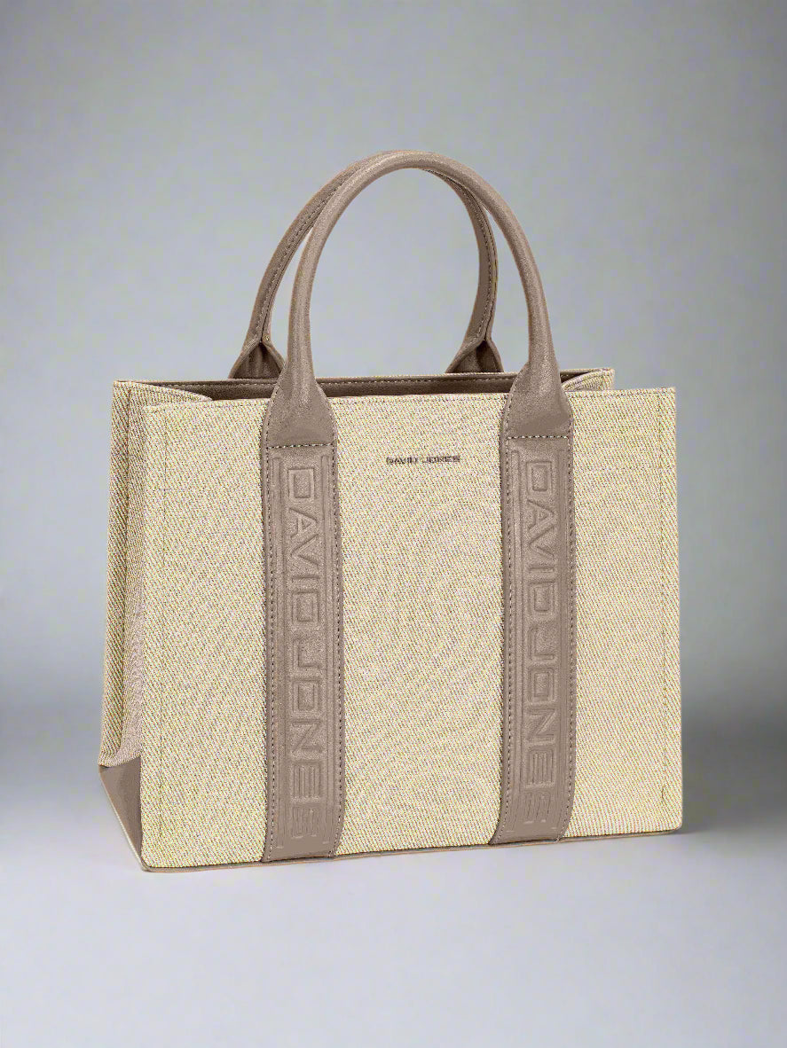 Beige handbag with brown handles and straps on a white background