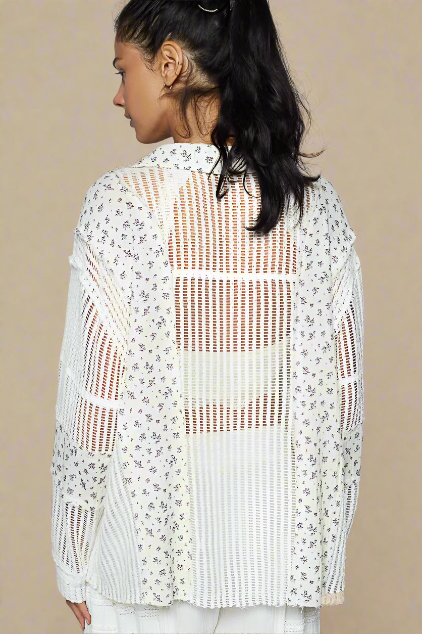 Woman wearing a white crochet top with floral patterns on a beige background