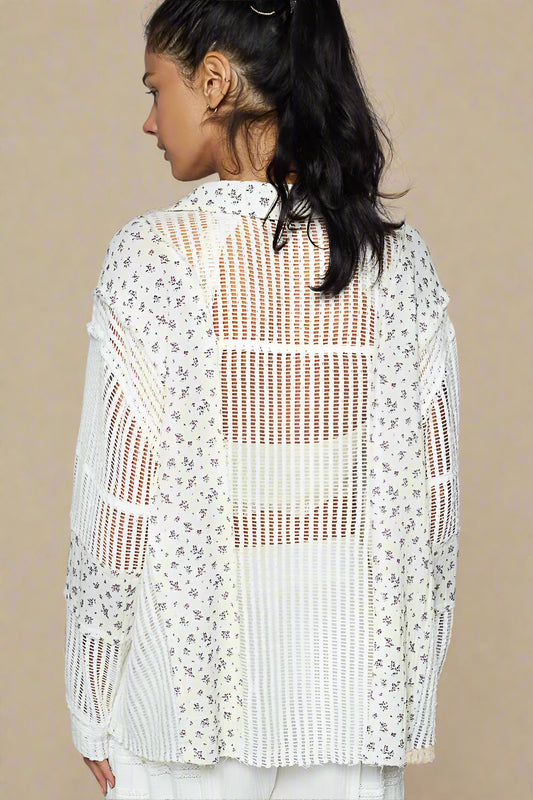 Woman wearing a white crochet top with floral patterns on a beige background