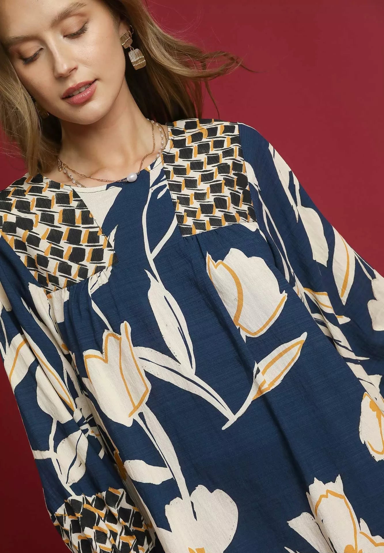 Woman wearing a floral dress with a red background