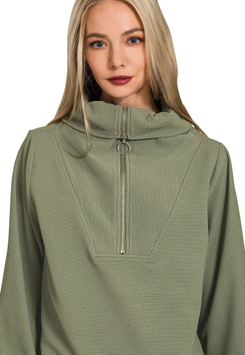 Woman wearing a green pullover with a zipper on a white background