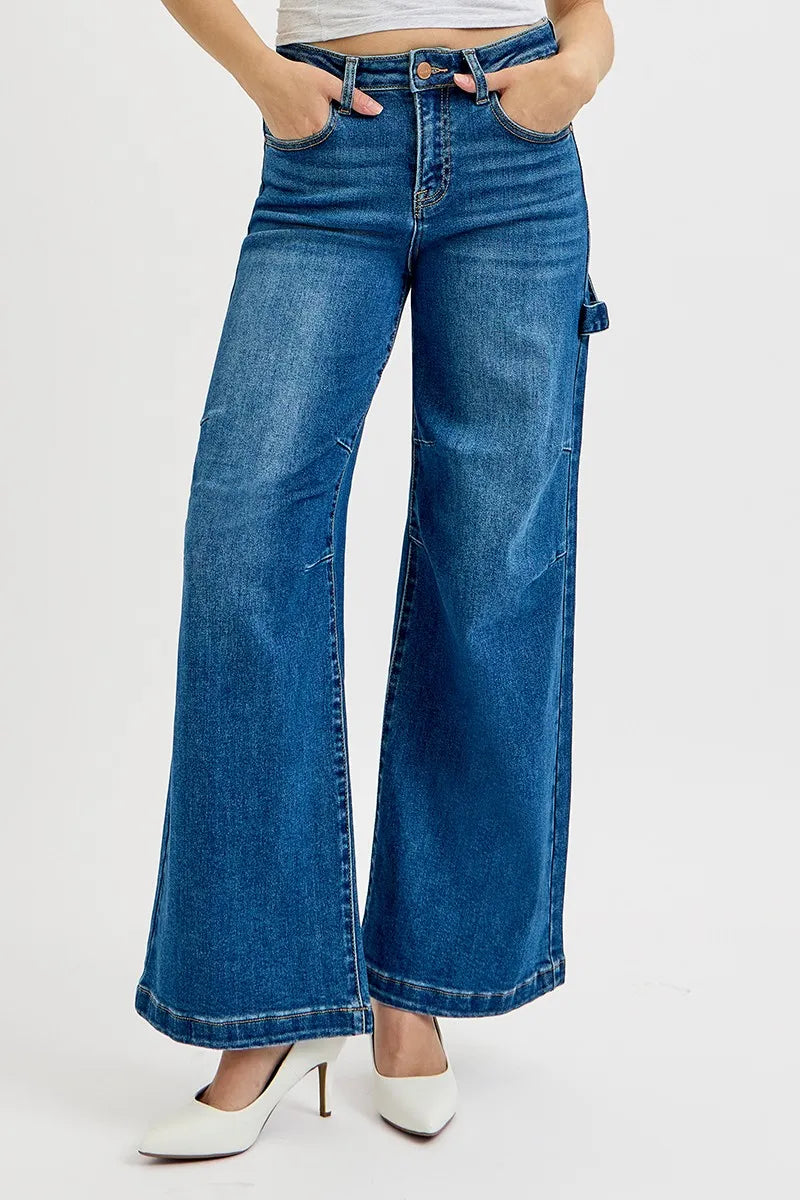 Blue wide-leg jeans worn by a person on a white background