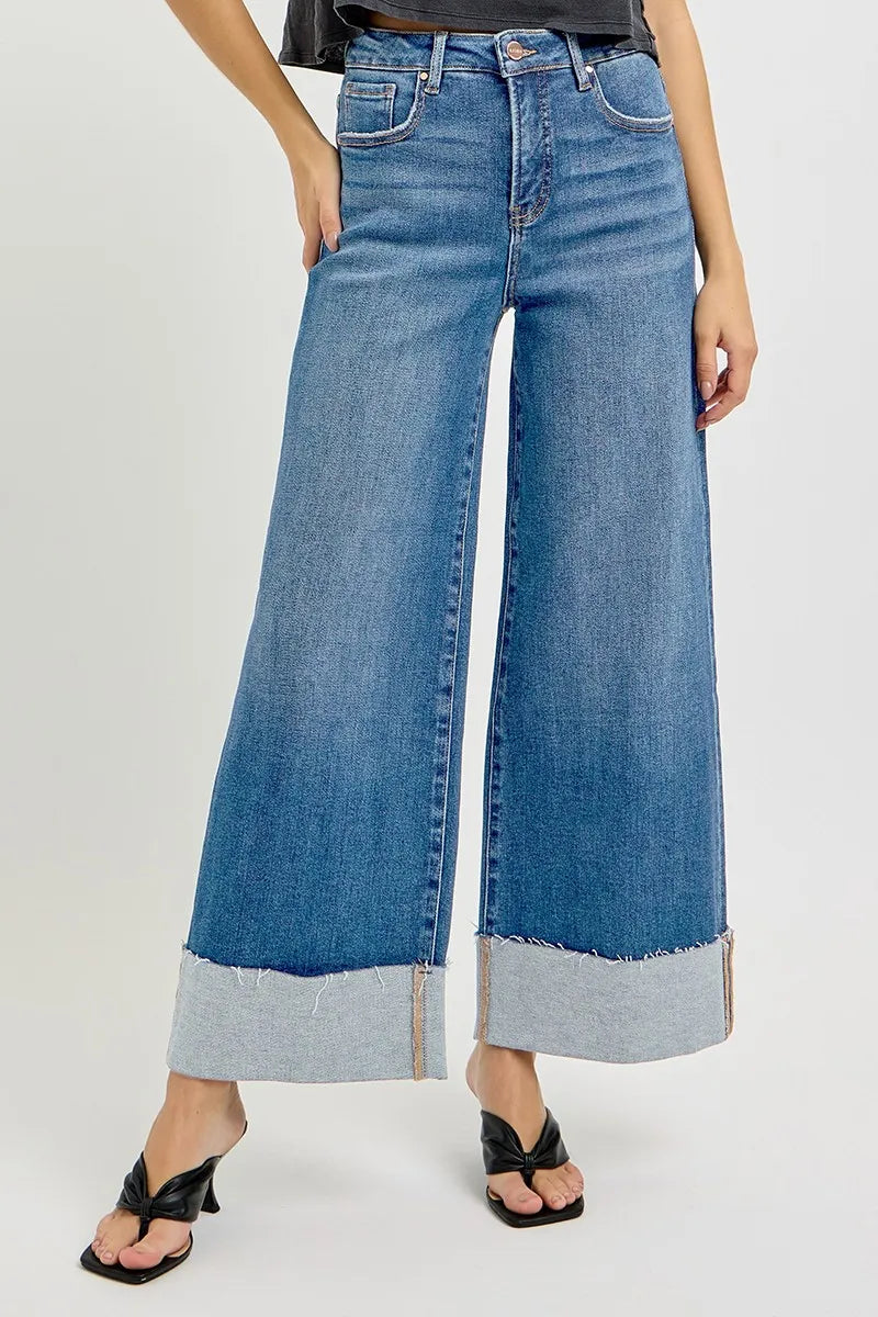 Wide-leg jeans with a light blue bottom section on a white background