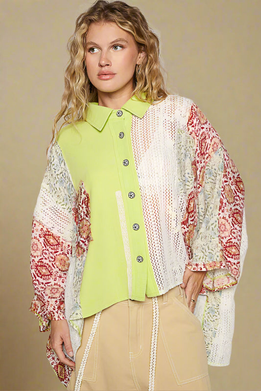 Woman wearing a green shirt with a colorful patterned jacket against a plain background