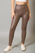 Brown leather leggings worn by a person on a gray background