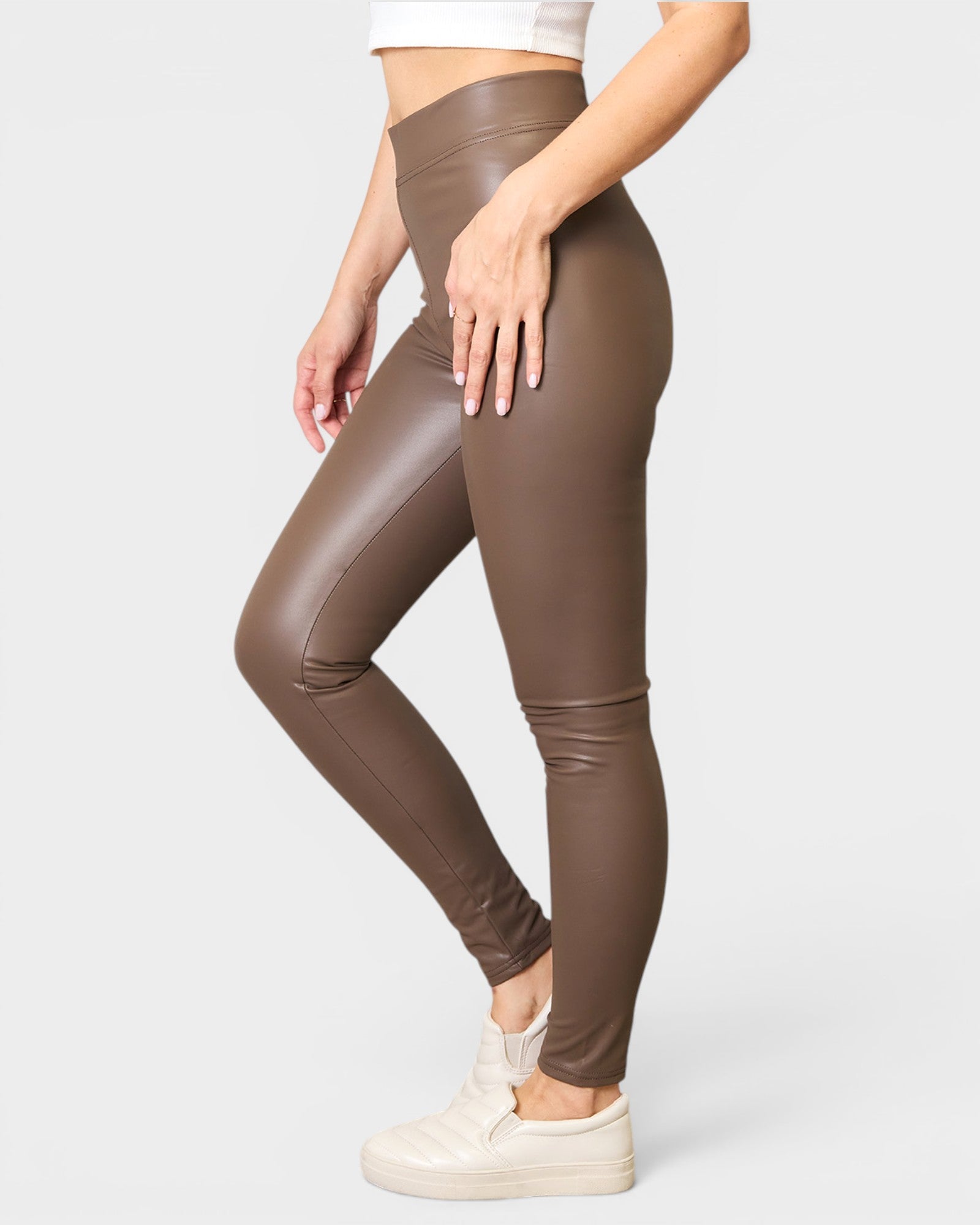 Brown leggings worn by a person on a white background