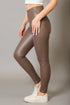 Brown leggings worn by a person on a gray background