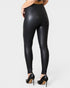 Black leather leggings worn by a person on a white background