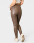 Brown leather leggings worn by a person on a white background