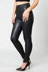 Black leather leggings worn by a person on a white background