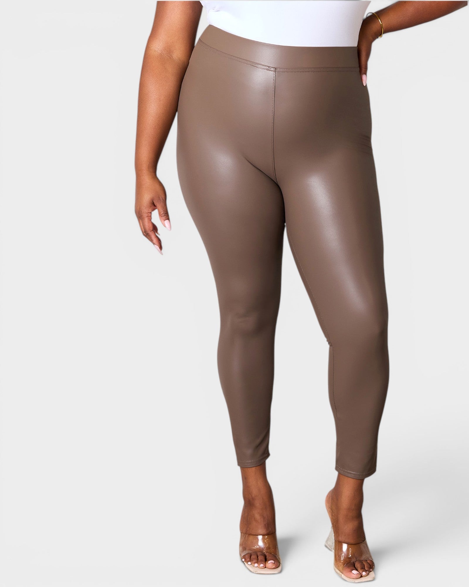Brown leggings worn by a person on a white background