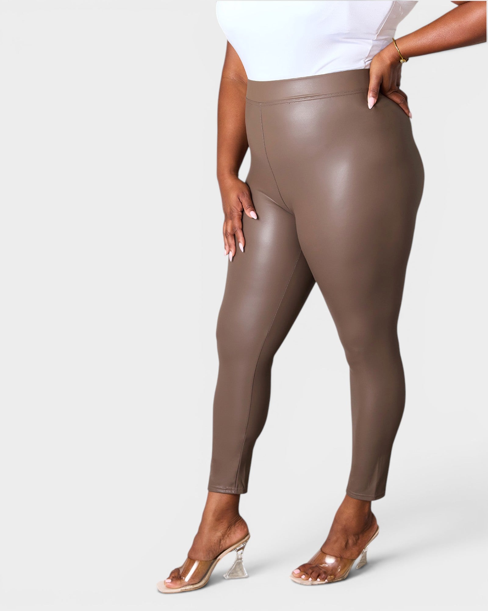 Brown leggings worn by a person on a white background
