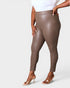 Brown leggings worn by a person on a white background