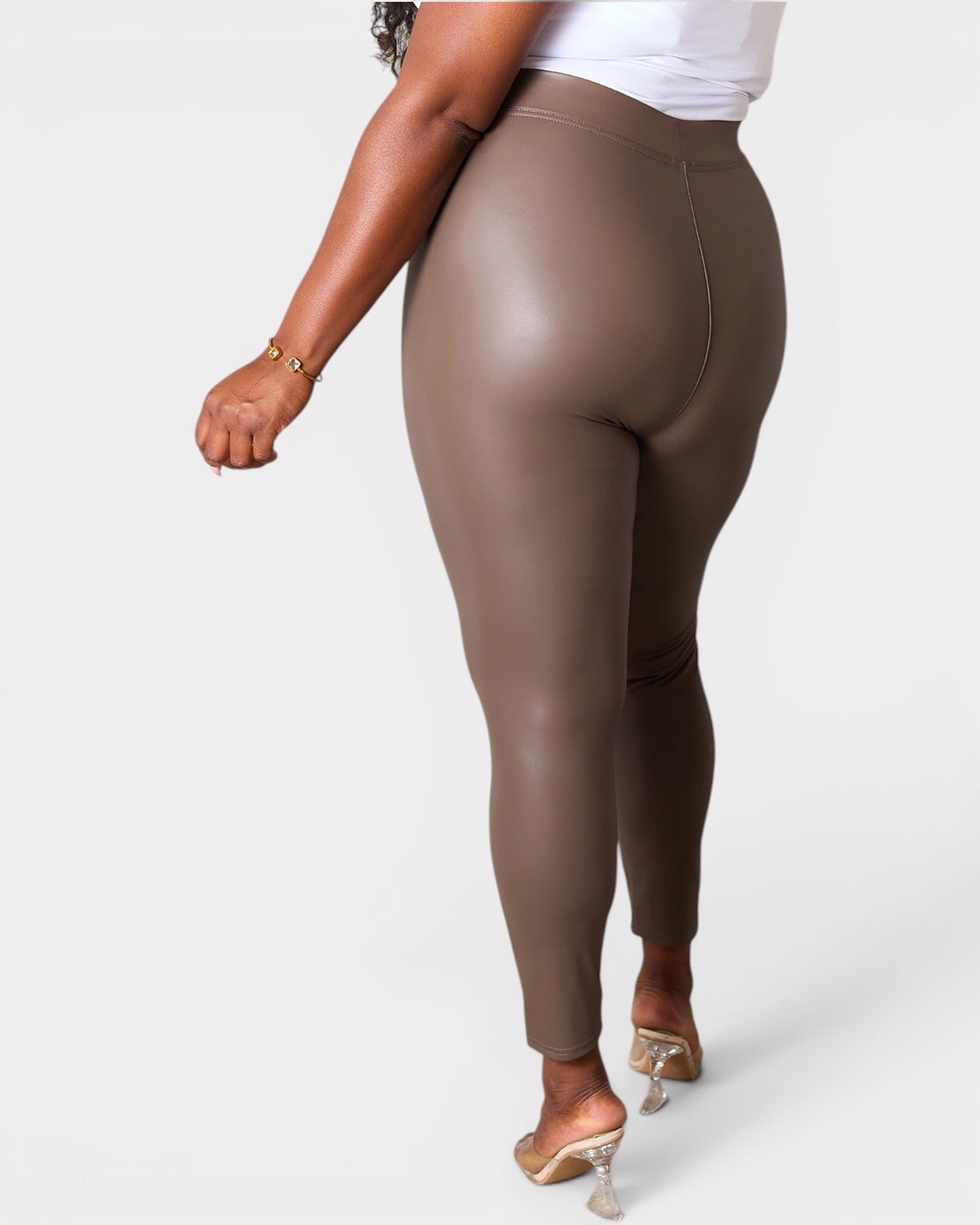 Brown leggings worn by a person on a white background
