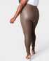Brown leggings worn by a person on a white background