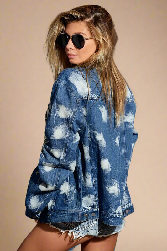 Woman wearing a blue denim jacket with cloud pattern indoors