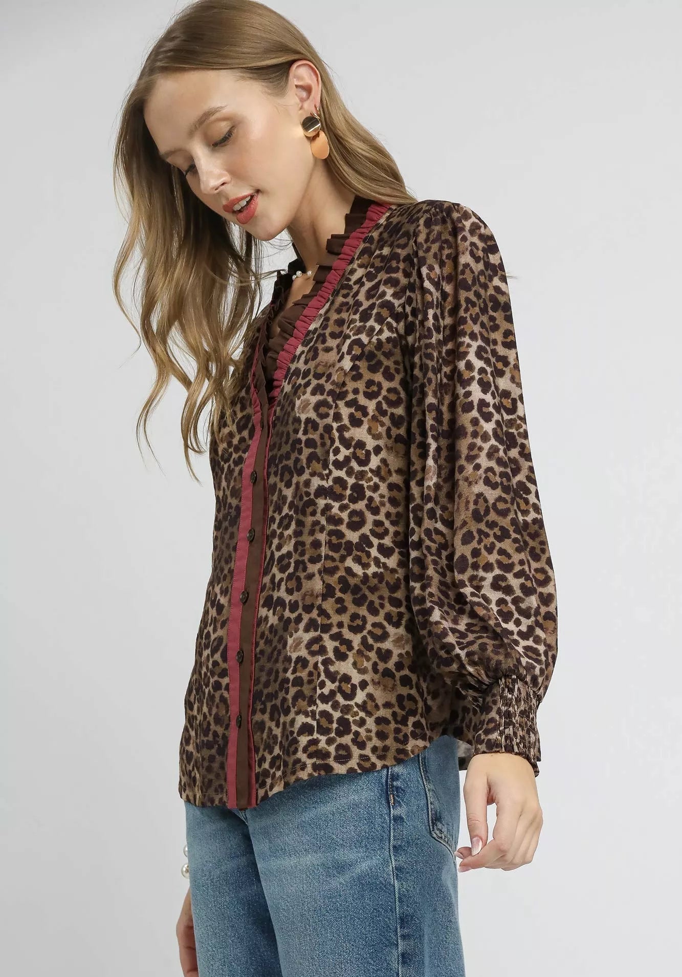 Woman wearing a leopard print top on a white background