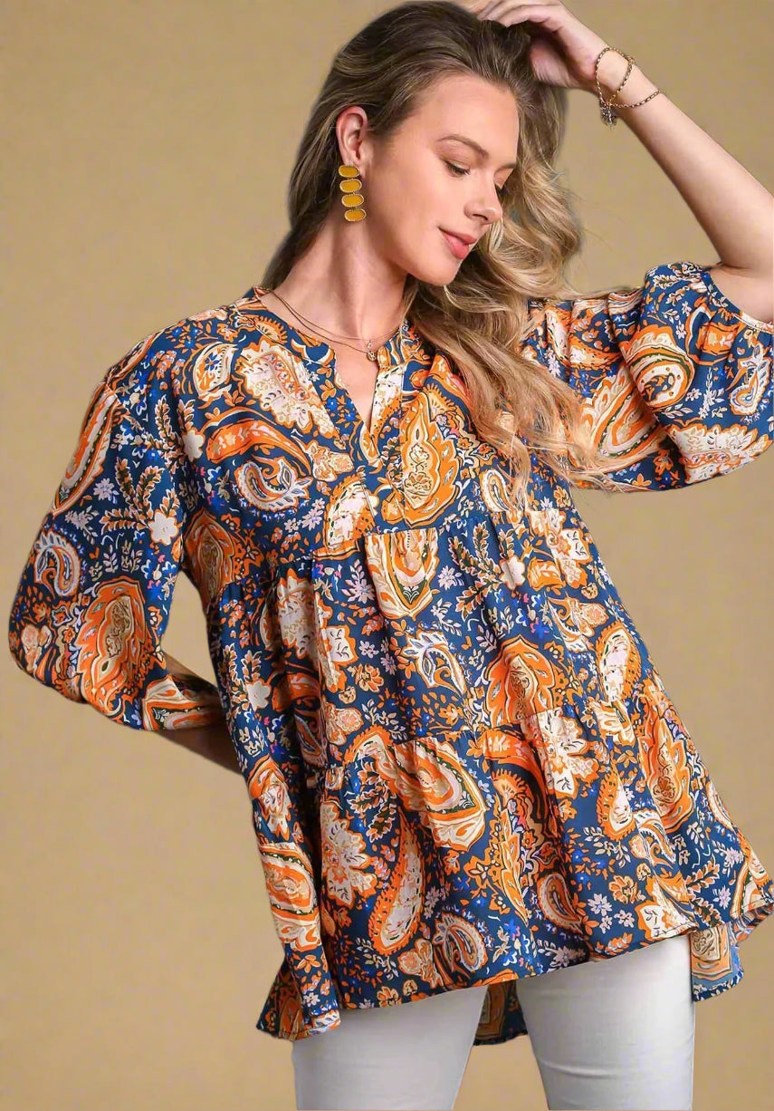 Woman wearing a patterned blouse with a beige background