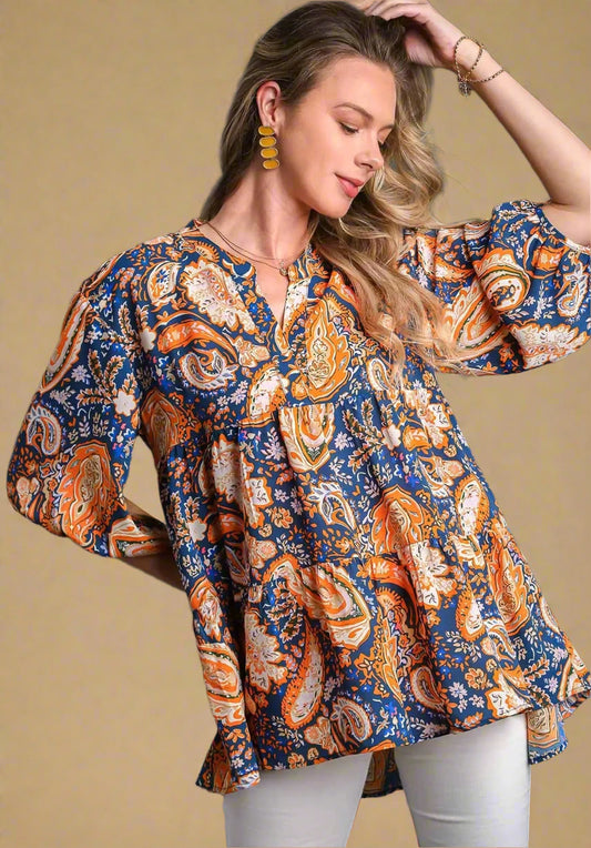Woman wearing a patterned blouse with a beige background