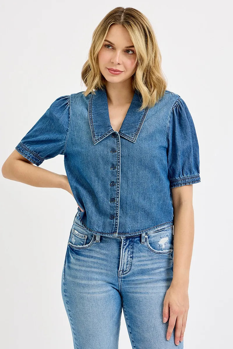Woman wearing a denim shirt and jeans on a white background