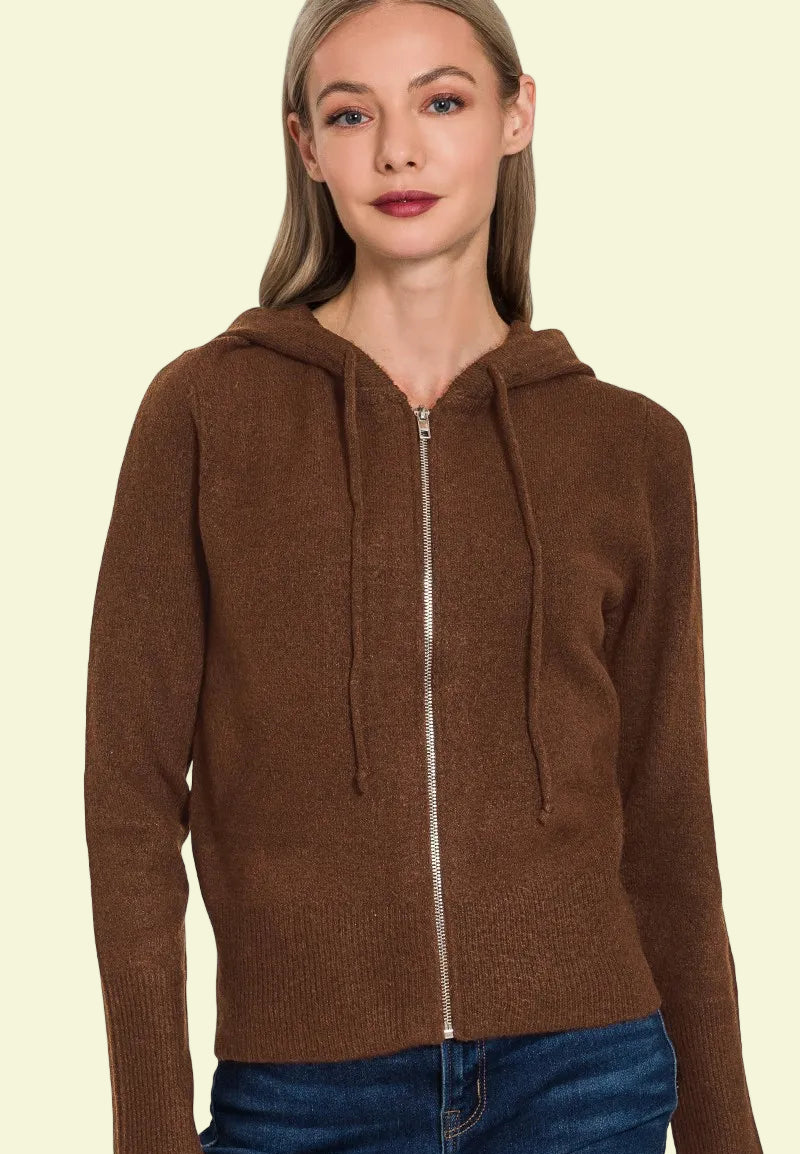 Woman wearing a brown zip-up hoodie on a white background