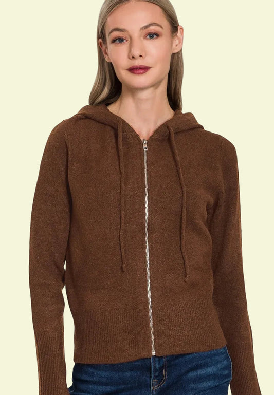 Woman wearing a brown zip-up hoodie on a white background