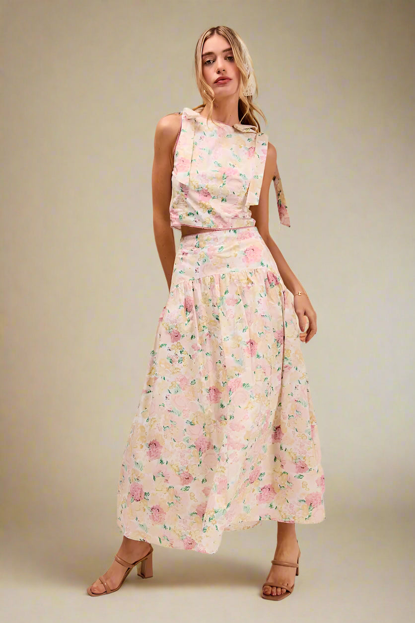 Woman wearing a floral two-piece dress on a beige background