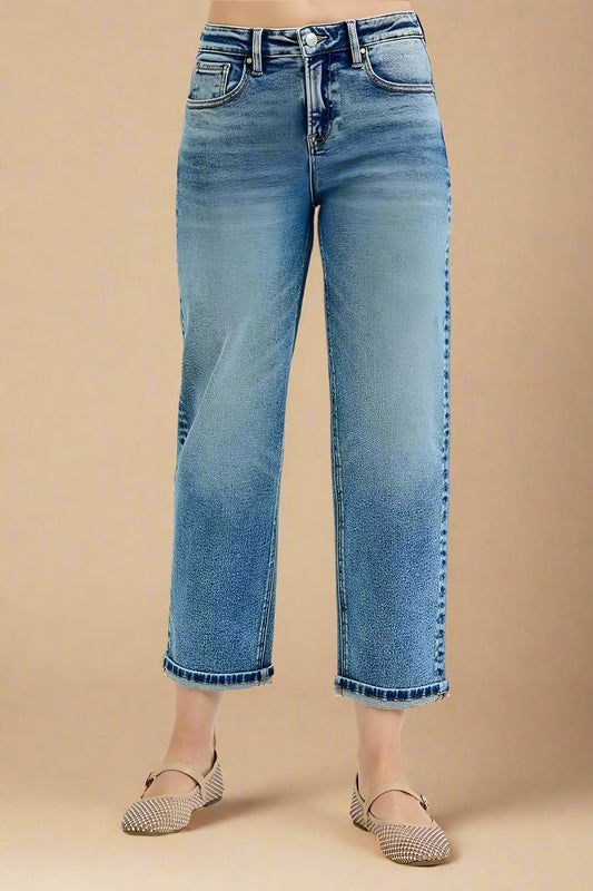 Blue jeans worn by a person on a white background