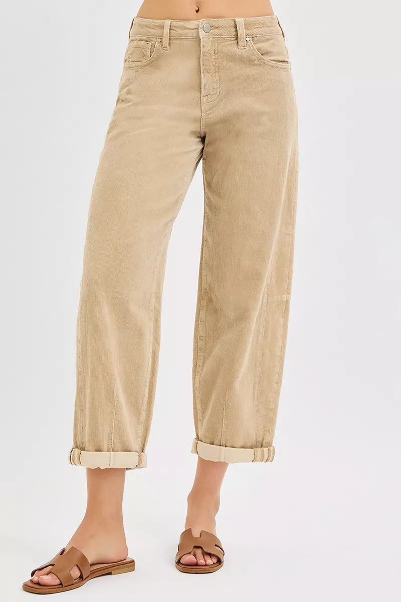 Beige jeans worn by a person on a white background