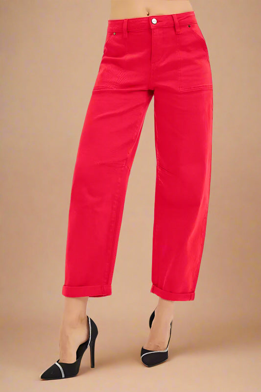 Red pants worn by a person on a white background