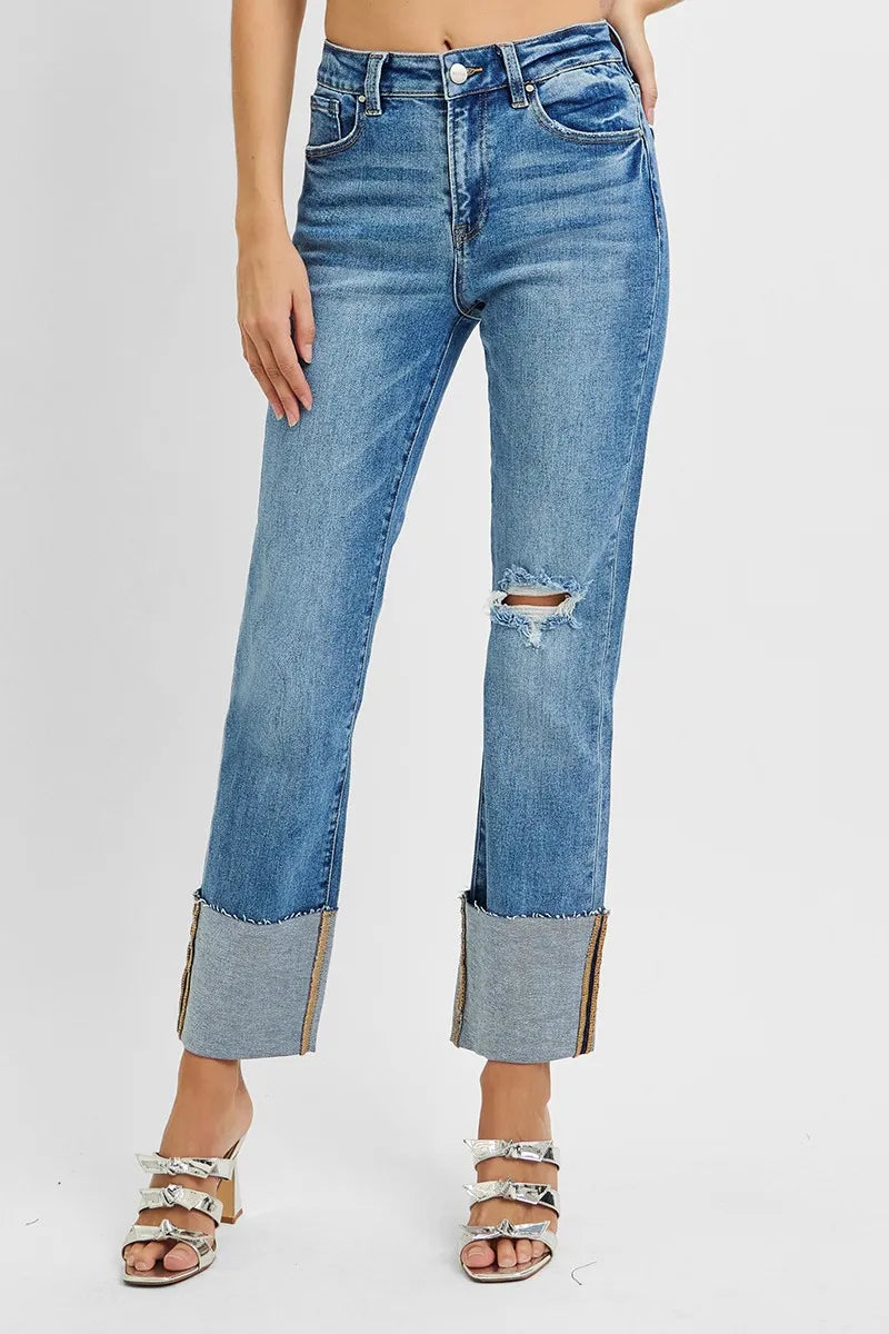 Blue jeans with distressed details on a white background