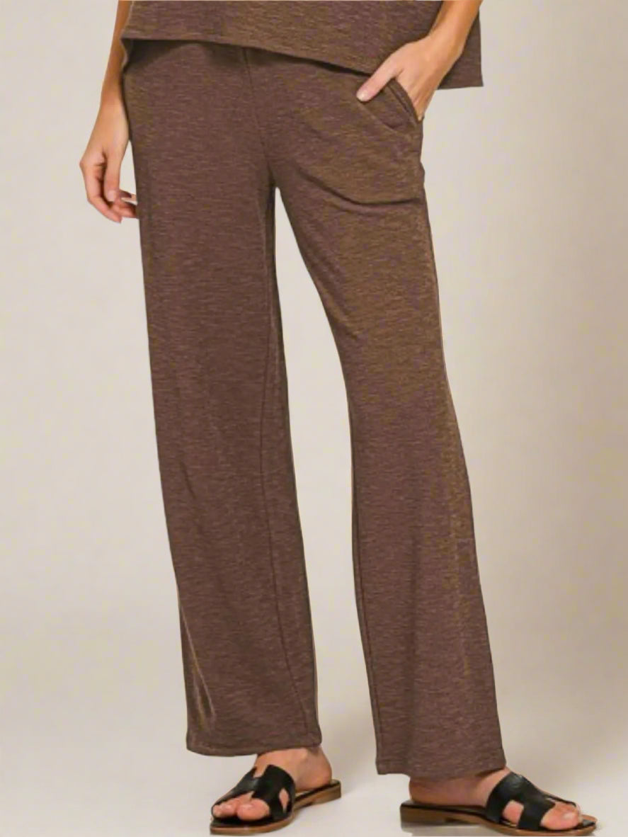 Brown pants worn by a person on a white background