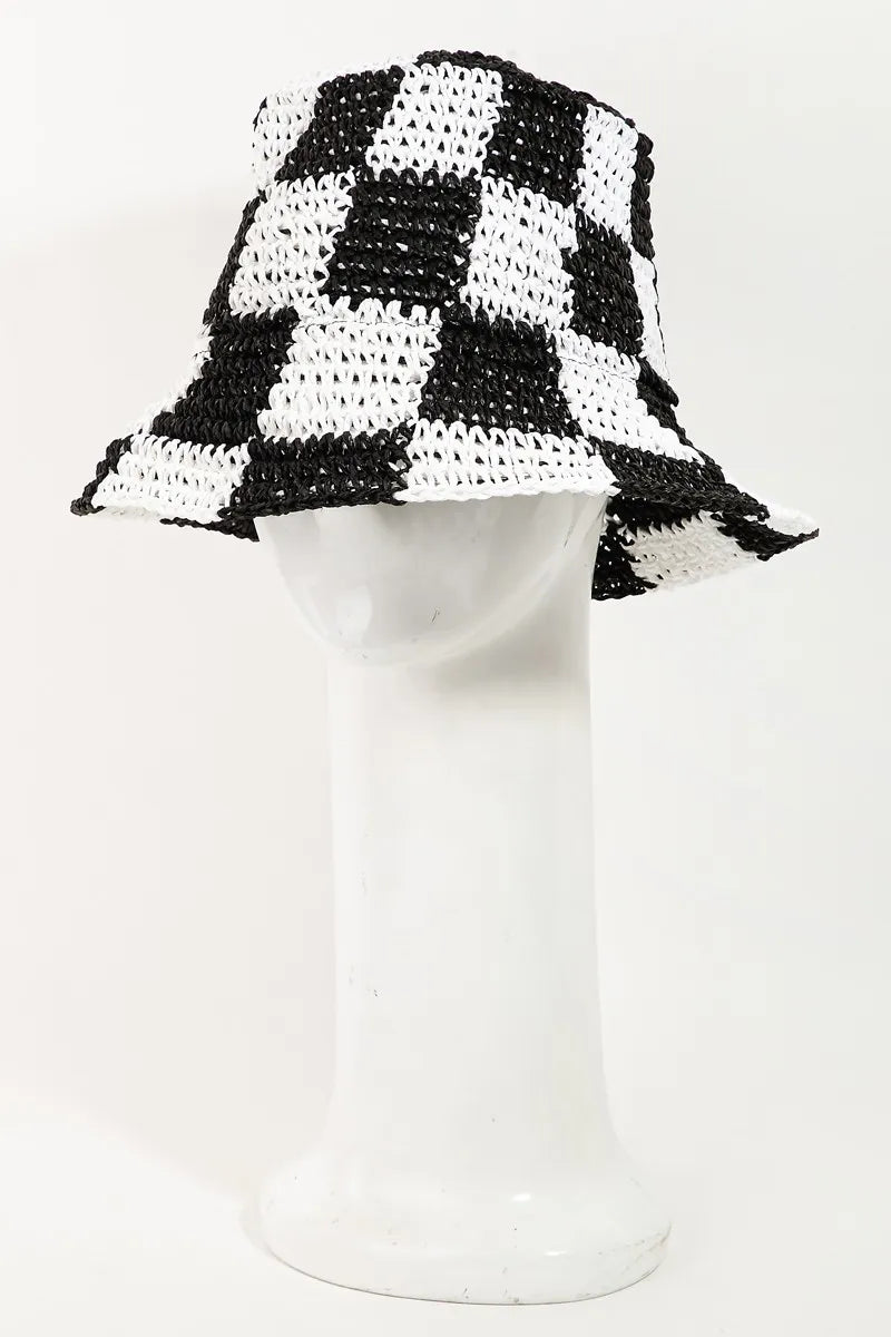 Black and white checkered bucket hat on a mannequin head against a white background