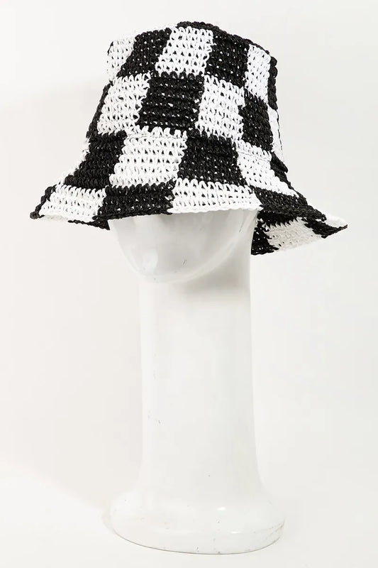 Black and white checkered bucket hat on a mannequin head against a white background