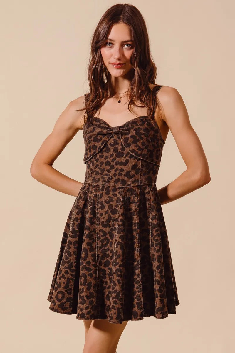 Woman wearing a leopard print dress against a beige background