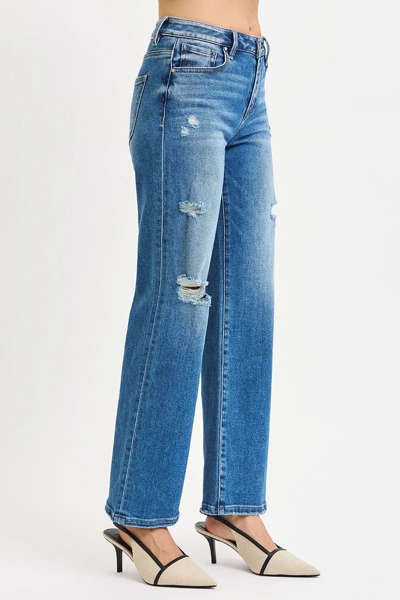 Blue jeans with slight distressing on a white background