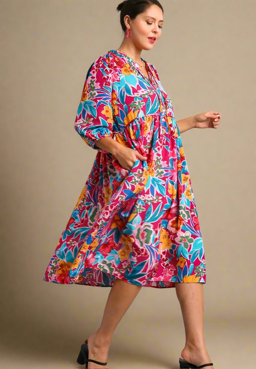 Woman wearing a colorful dress on a beige background