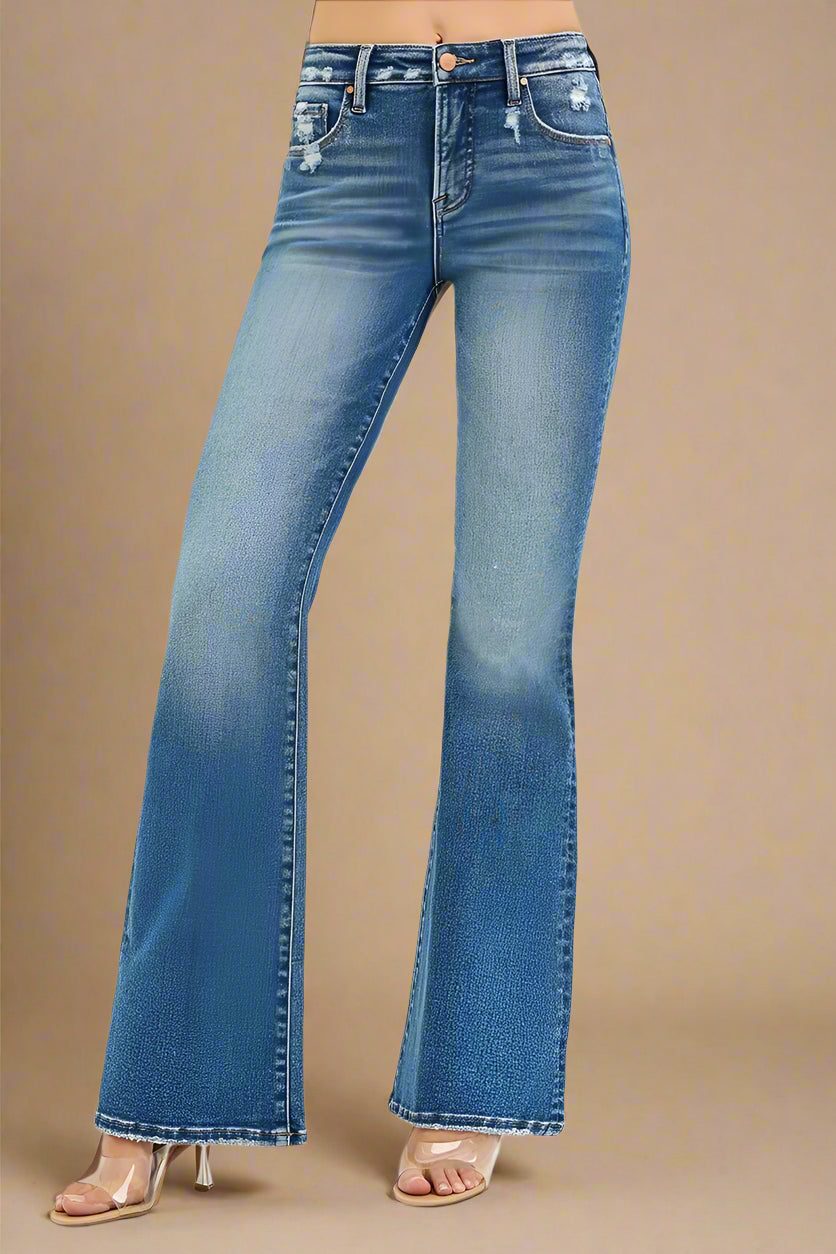 Blue flared jeans on a beige background