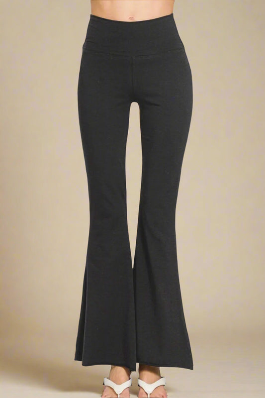 Black flared pants on a beige background