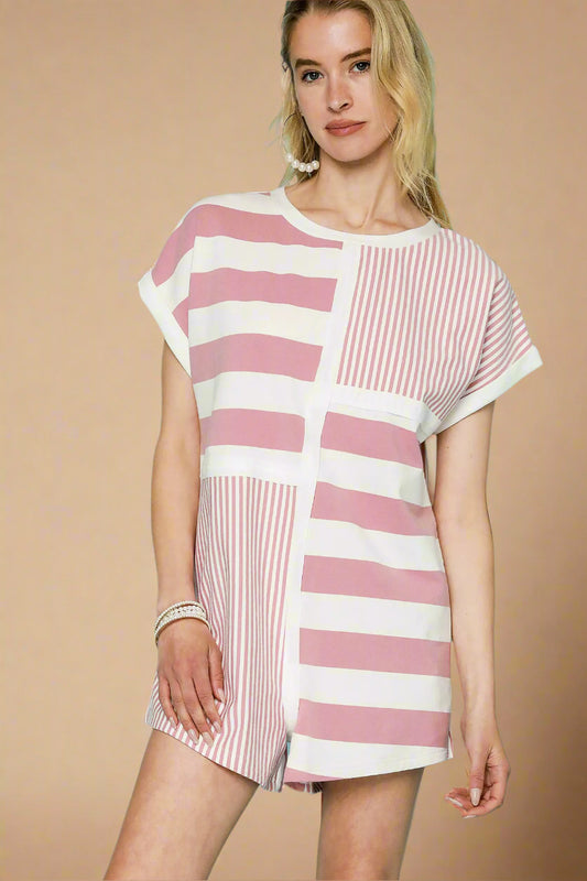 Woman wearing a pink and white striped dress against a light beige background