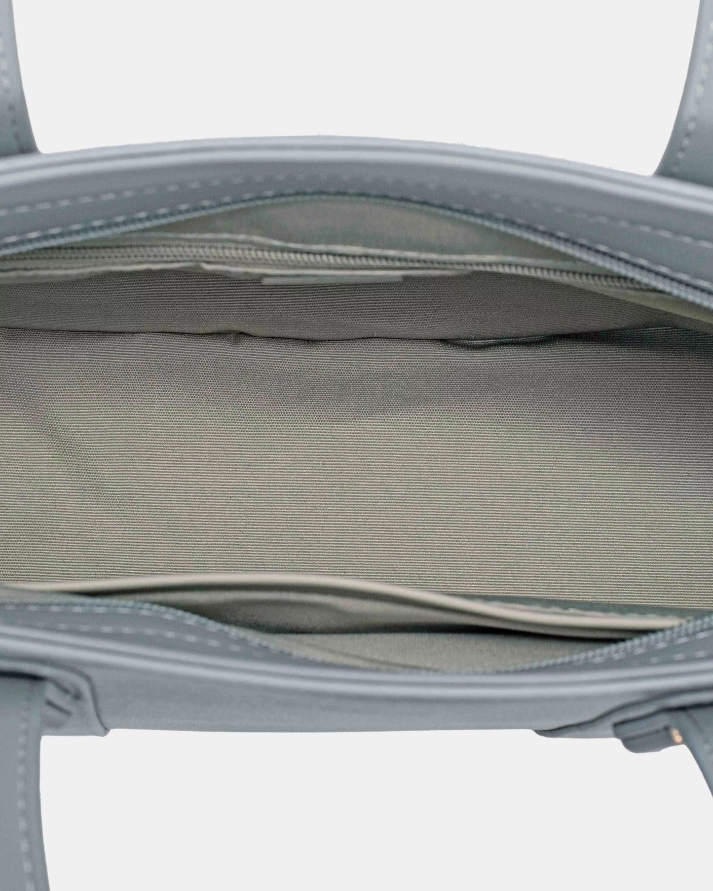 Gray handbag with visible stitching on a light gray background