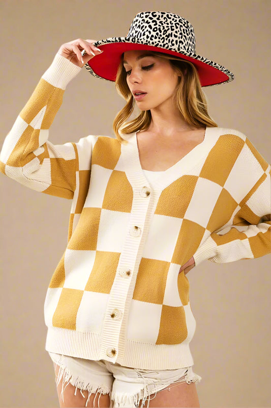 Woman wearing a checkered cardigan, shorts, and a leopard print hat on a white background