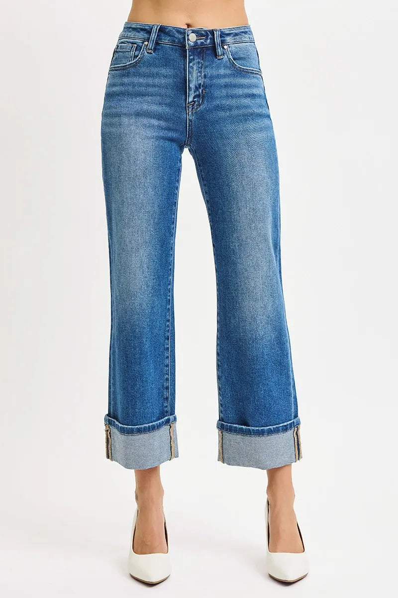 Blue jeans with rolled-up cuffs on a white background