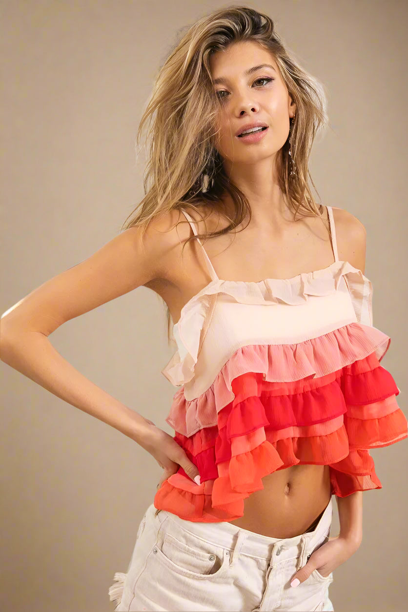 Woman wearing a colorful ruffled top in a casual setting