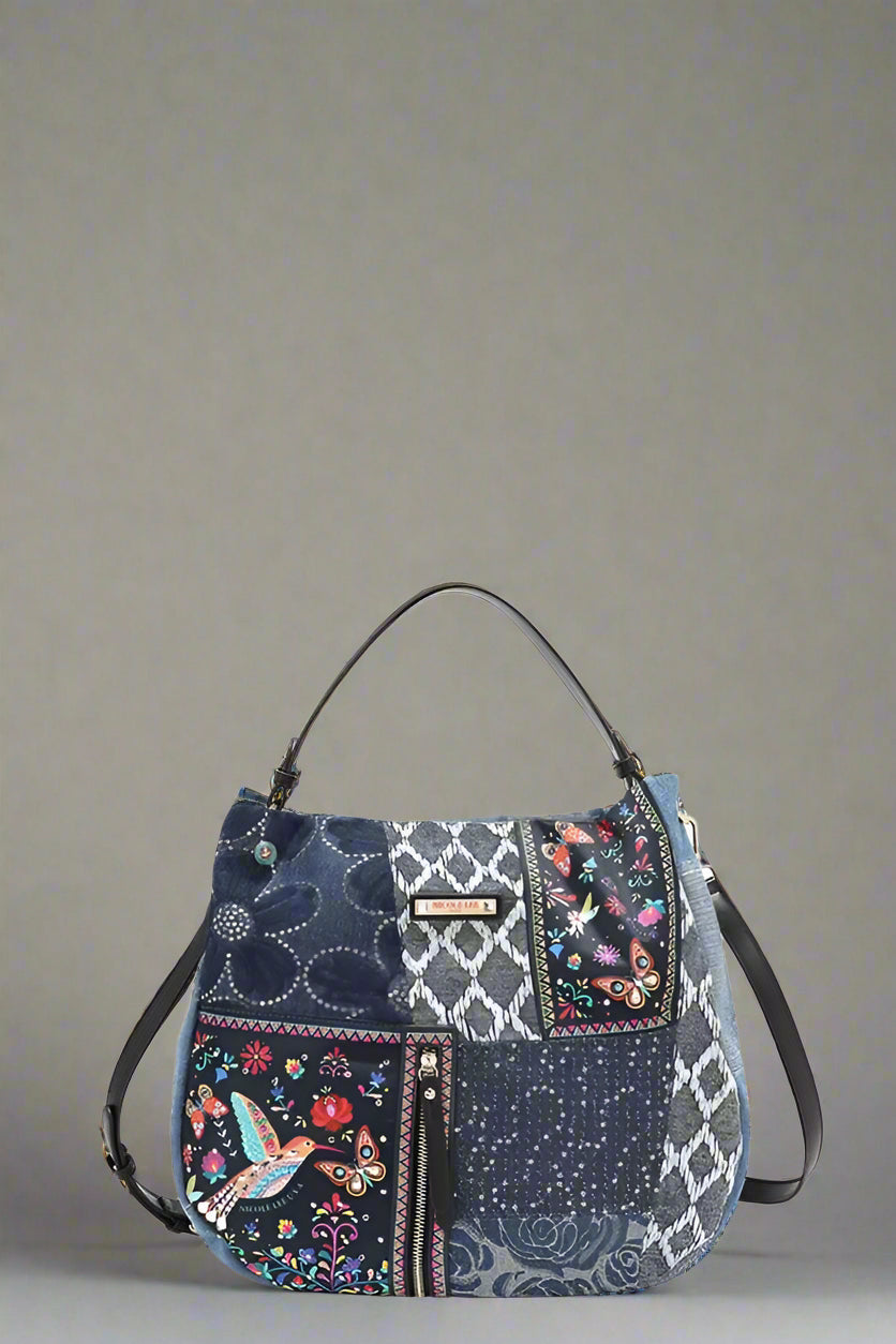 Multicolored patterned handbag with floral and geometric designs on a white background