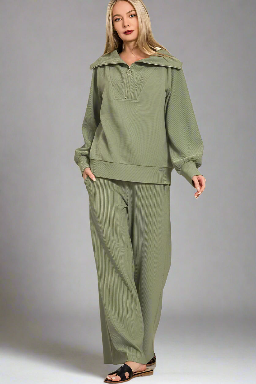 Woman wearing a light olive green outfit on a white background