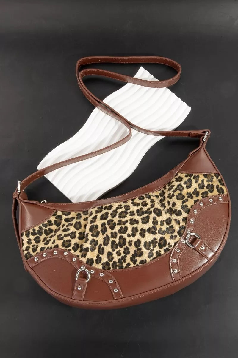 Brown handbag with leopard print pattern on a black background