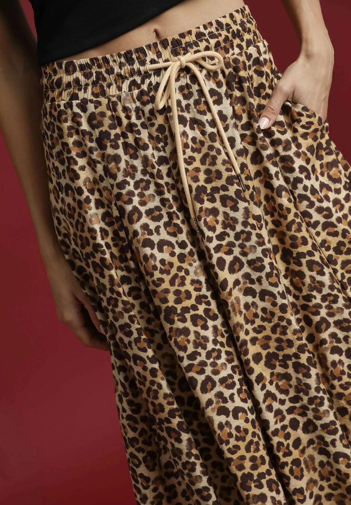 Leopard print skirt with a drawstring on a red background