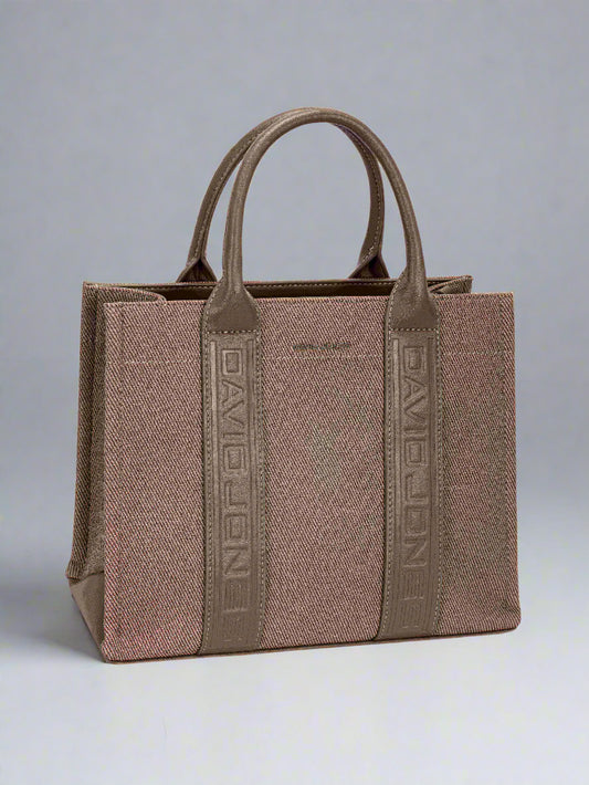 Brown handbag with visible brand logo on a light gray background